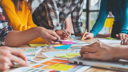 Diverse business people working together and brainstorming about marketing idea. Group of diverse business team planning financial strategy and talking about plan by using colorful stick notes. AIG53F