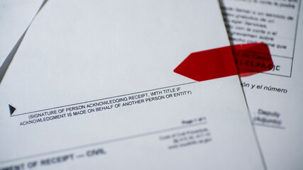 Lawsuit service notice red arrow showing where to sign, selective focus on signature line