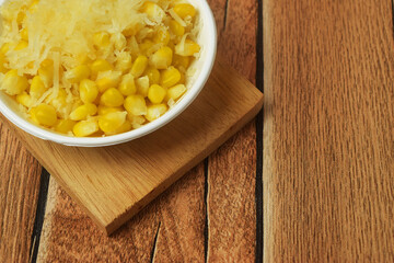 Closeup photo of some shaved corn sprinkled with sweet cheese