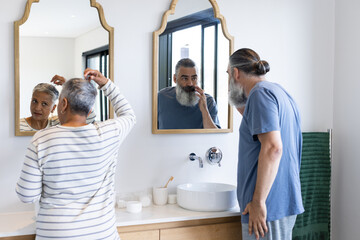 Grooming in bathroom, senior couple standing in front of mirrors