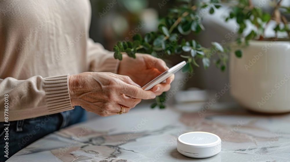 Aufkleber elderly person using a smartphone to control a smart thermostat stock photo with copy space