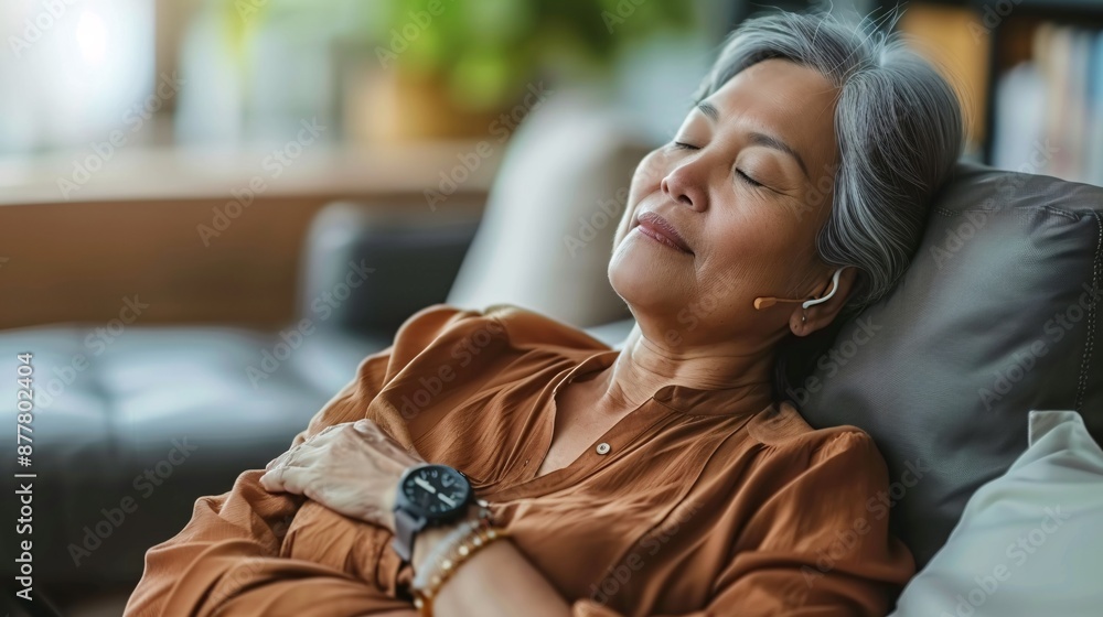 Poster senior woman using a wearable device to monitor sleep patterns stock photo with copy space