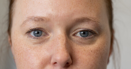 Close-up of woman with blue eyes, focusing on facial features