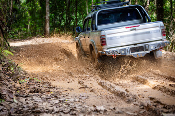 Cars running on off-road roads and splashing mud on natural paths. Off-road travel on muddy road. Suv offroad 4wd car rides through muddy puddle, off-road track road, with a big splash.