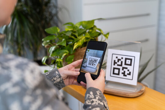 Scanning QR code, person using smartphone in medical clinic environment