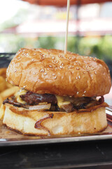 Cheeseburger With Salad And Tomato On a wooden board 