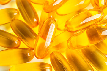 Fish oil capsules omega 3 vitamin with EPA and DHA on white background.
