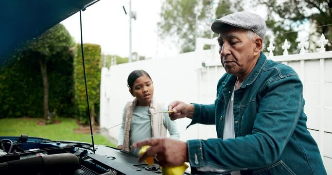 Senior man, teaching and kid with car maintenance for checking oil, service or engine at home. Mature male person with dip stick for vehicle safety, repair or inspection by little girl outside house