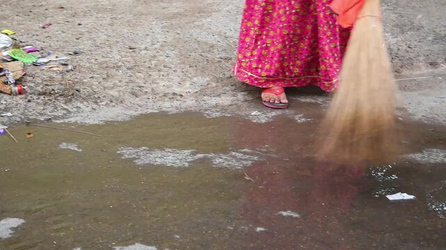 shot of sweepers cleaning the street of India