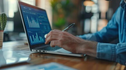 Cropped view of businessman's hands checking data and sales indicators on laptop Create strategies to optimize operations and increase business performance. Business information for success