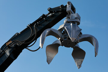 excavator arm with metal scrap grabber