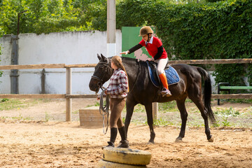 Rider engages in equestrian training with close supervision.