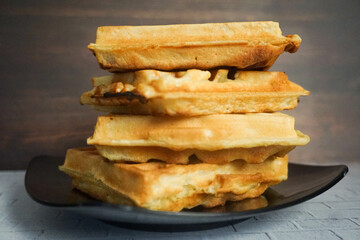 Homemade Waffles, delicious, close up. Waffle is a dish made from leavened batter or dough that is cooked between two plates that are patterned to give a characteristic size, shape, and surface impres