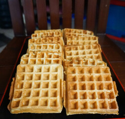 Homemade Waffles, delicious, close up. Waffle is a dish made from leavened batter or dough that is cooked between two plates that are patterned to give a characteristic size, shape, and surface impres