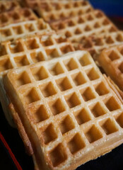 Homemade Waffles, delicious, close up. Waffle is a dish made from leavened batter or dough that is cooked between two plates that are patterned to give a characteristic size, shape, and surface impres