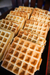 Homemade Waffles, delicious, close up. Waffle is a dish made from leavened batter or dough that is cooked between two plates that are patterned to give a characteristic size, shape, and surface impres