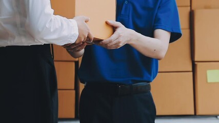 Young cheerful delivery man with parcel near car full of cardboard boxes, full length shot. Shipping service concept