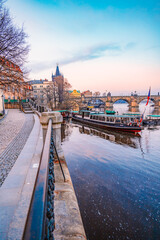 Obraz premium View of the city of Prague castle, boat trips and the Vltava river with Charles bridge in Prague, Czech Republic.