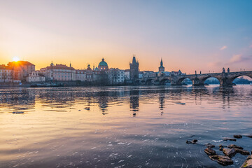 Fototapeta premium View of the city of Prague. Vltava river with Old Town Bridge Tower on Charles bridge in Prague, Czech Republic.