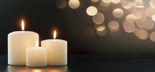 Three candles casting a warm glow against a bokeh light background for a reflective mood