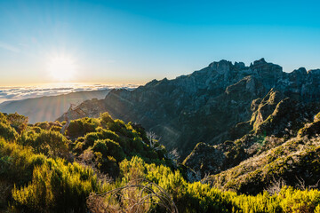 Hiking on the highest peak of Madeira Pico Ruivo next to the cottage Abrigo do Pico Ruivo. Views of...