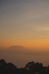 travel and people activity concept with twilight sky before sunrise with mountain and fog on foreground
