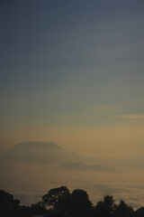 travel and people activity concept with twilight sky before sunrise with mountain and fog on foreground
