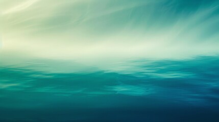 Obraz premium An abstract background with a gradient of cool blues and greens, evoking a sense of tranquility and calm
