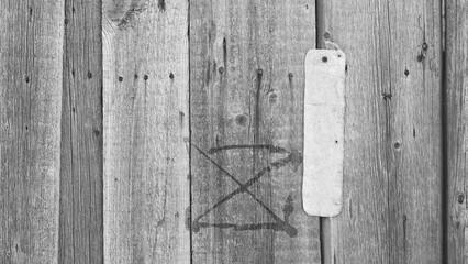 Graffiti Symbol On Rustic Wooden Plank Close-Up Monochrome