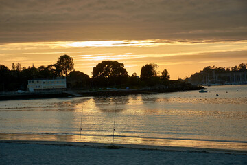Fototapeta premium Sunset at Ladeira Beach in Sabaris with a Fisherman on the Horizon