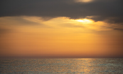 Sunset on the sea coast. Seascape orange sunset.