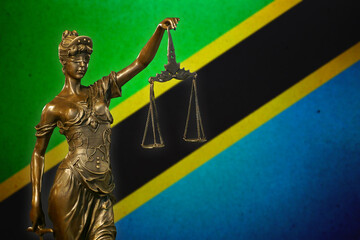 Obraz premium Lady Justice before a flag of Tanzania