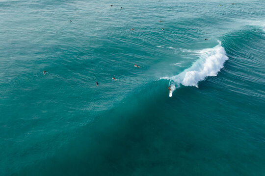 Surfer comes out of barrel while surfing in Hawaii