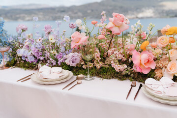Vibrant florals and colorful place setting on wedding table