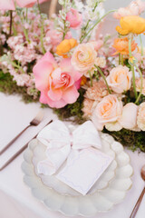 Vibrant florals and colorful place setting on wedding table