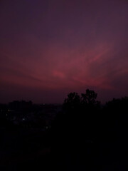 time lapse of clouds at night, sunset scenery view of red sky background,  silhouette of trees and buildings, nature photography