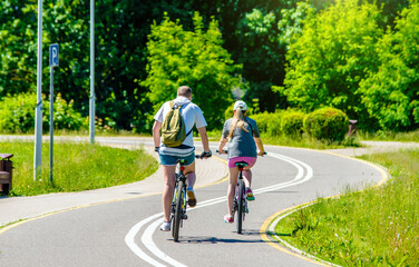 Fototapeta premium Cyclists ride on the bike path in the city Park 