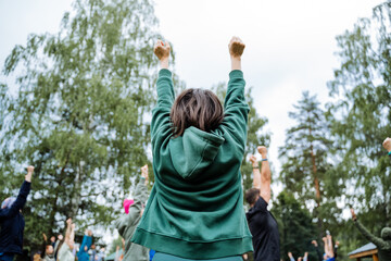Fototapeta premium In an outdoor community event, a group is joyfully celebrating, showcasing diversity, togetherness, and cheer in a lively atmosphere filled with happiness and excitement
