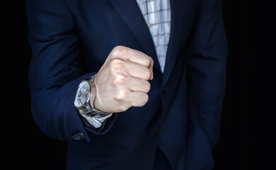 Fototapeta premium A young executive extending his arm and fist pumping 