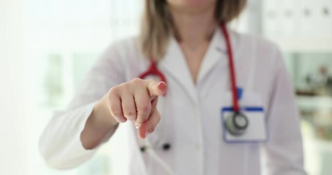 Woman doctor points forward emphasizing proactive health maintenance