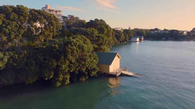 Boatshed pier on the coastline of Herne Bay, Auckland at sunset, New Zealand.