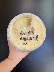 Coffee in a plastic cup with hand 