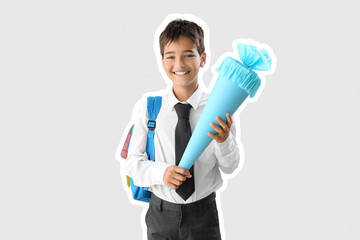Little boy with blue school cone on light background
