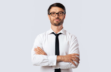 Businessman Standing Crossing Hands Looking At Camera Over White Background In Studio. Isolated,...