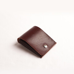 various leather wallets in various colors and cartoon cases with plain white backgrounds