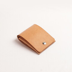 various leather wallets in various colors and cartoon cases with plain white backgrounds
