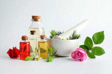 Aromatherapy. Different essential oils, flowers, mortar, pestle and fir twigs on white background