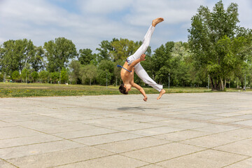 Teenager practicing capoeira , brazilian martial art