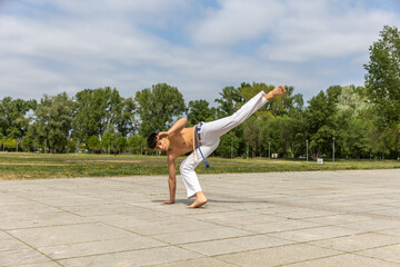 Teenager practicing capoeira , brazilian martial art