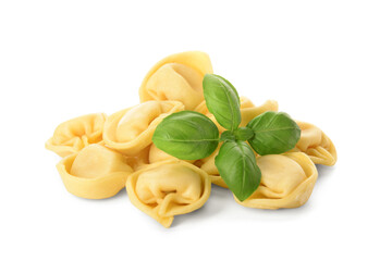 Raw dumplings and basil on white background